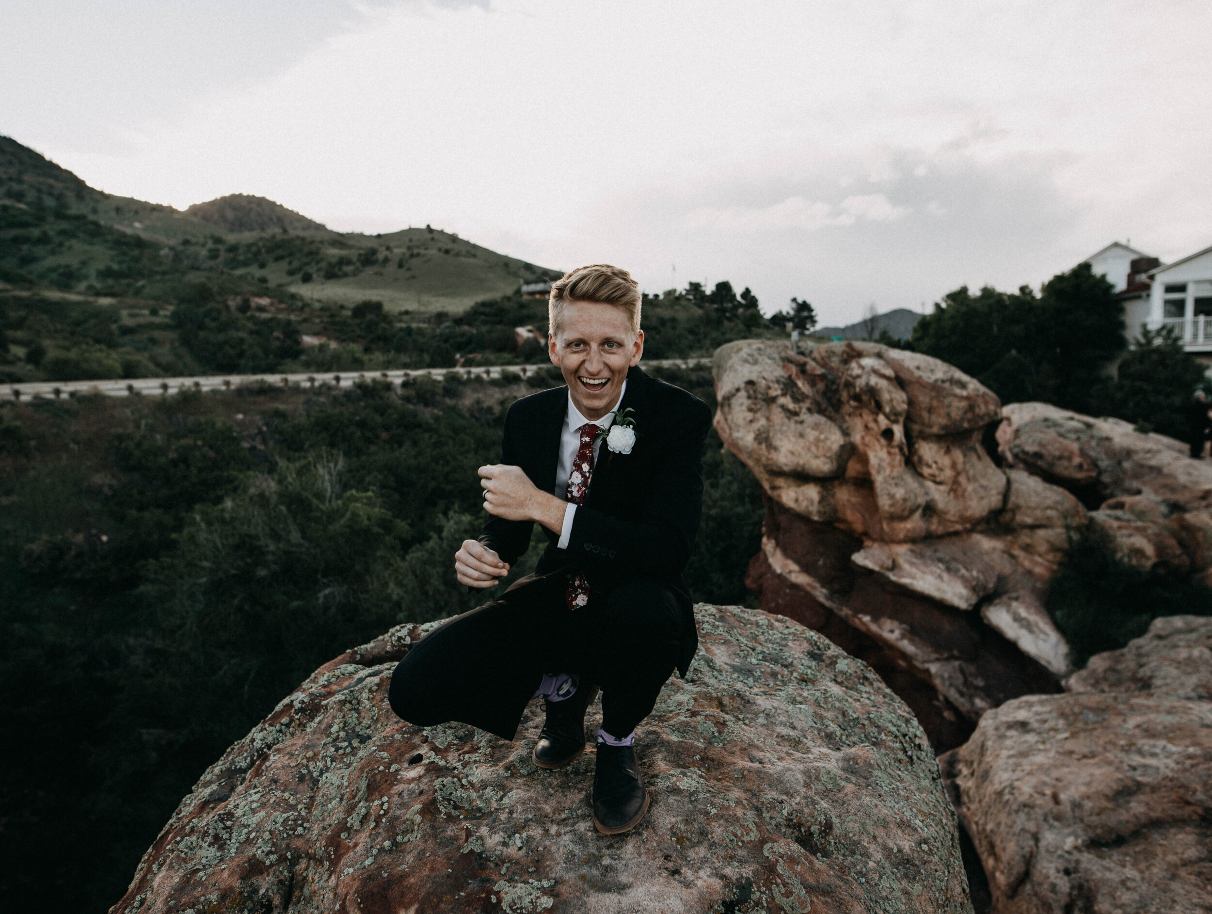 Daniel Lindeen sitting on a rock in the hills