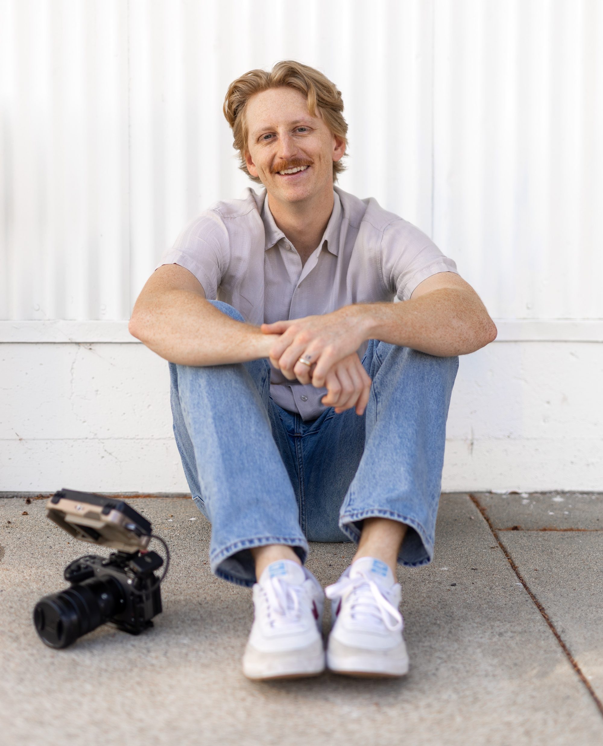 Daniel Lindeen sitting with his camera